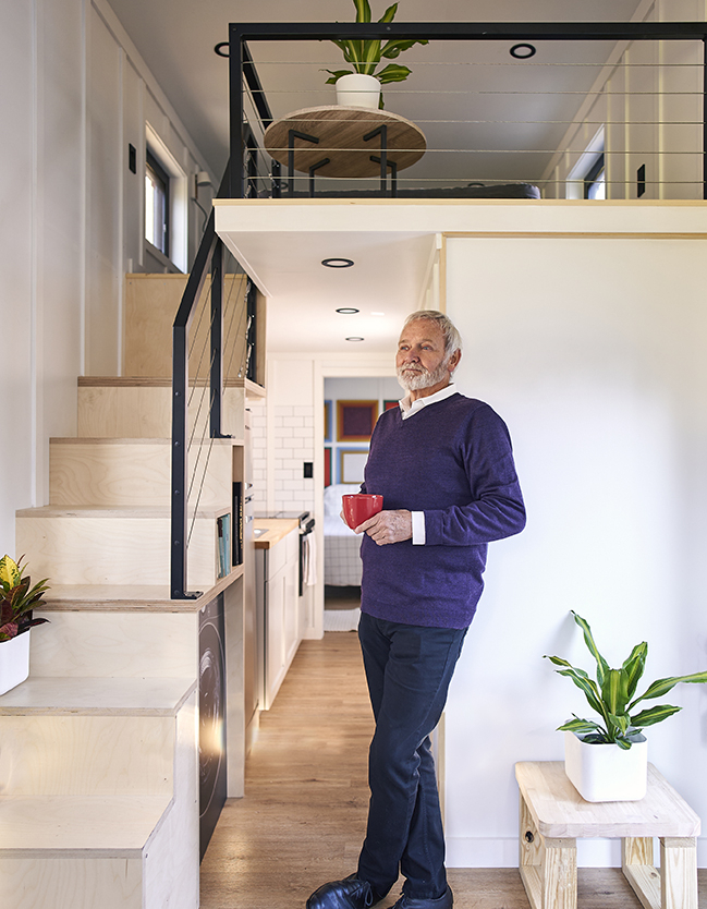 interior view of Via tiny home with a view of the kitchen and bedroom